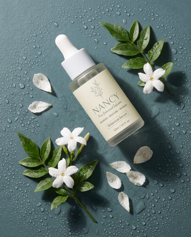 Nancy botanical serum flat lay — skincare product photography